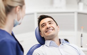 Patient smiling at dentist during exam