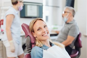 a person holding their cheek due to tooth pain