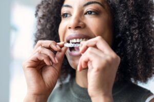 closeup of a woman putting in an aligner